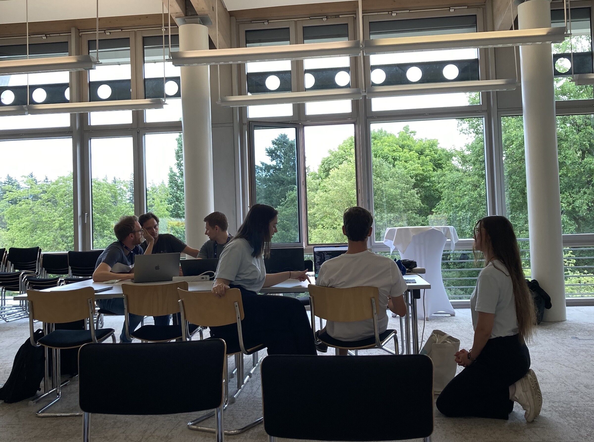 Neos team members working with contributors on advanced features