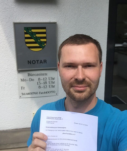Tobias with Neos Foundation e.V. registration documents in front of Notary sign