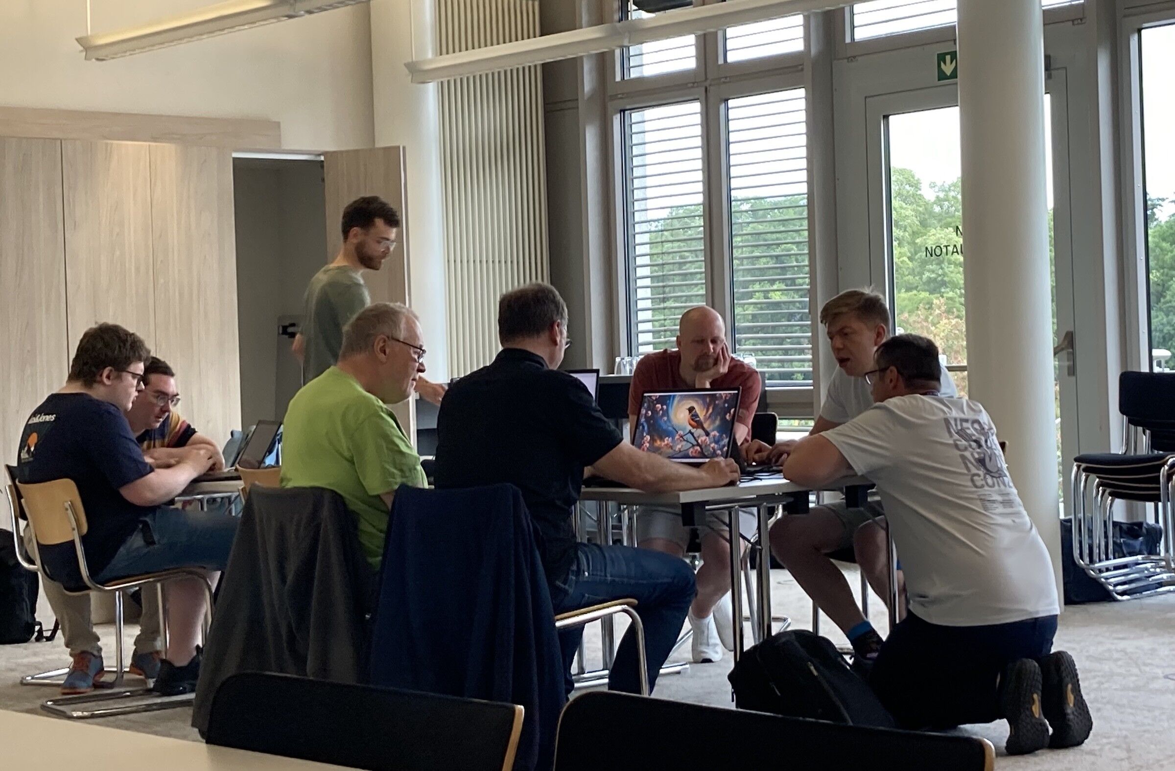 Neos contributors sitting at a table