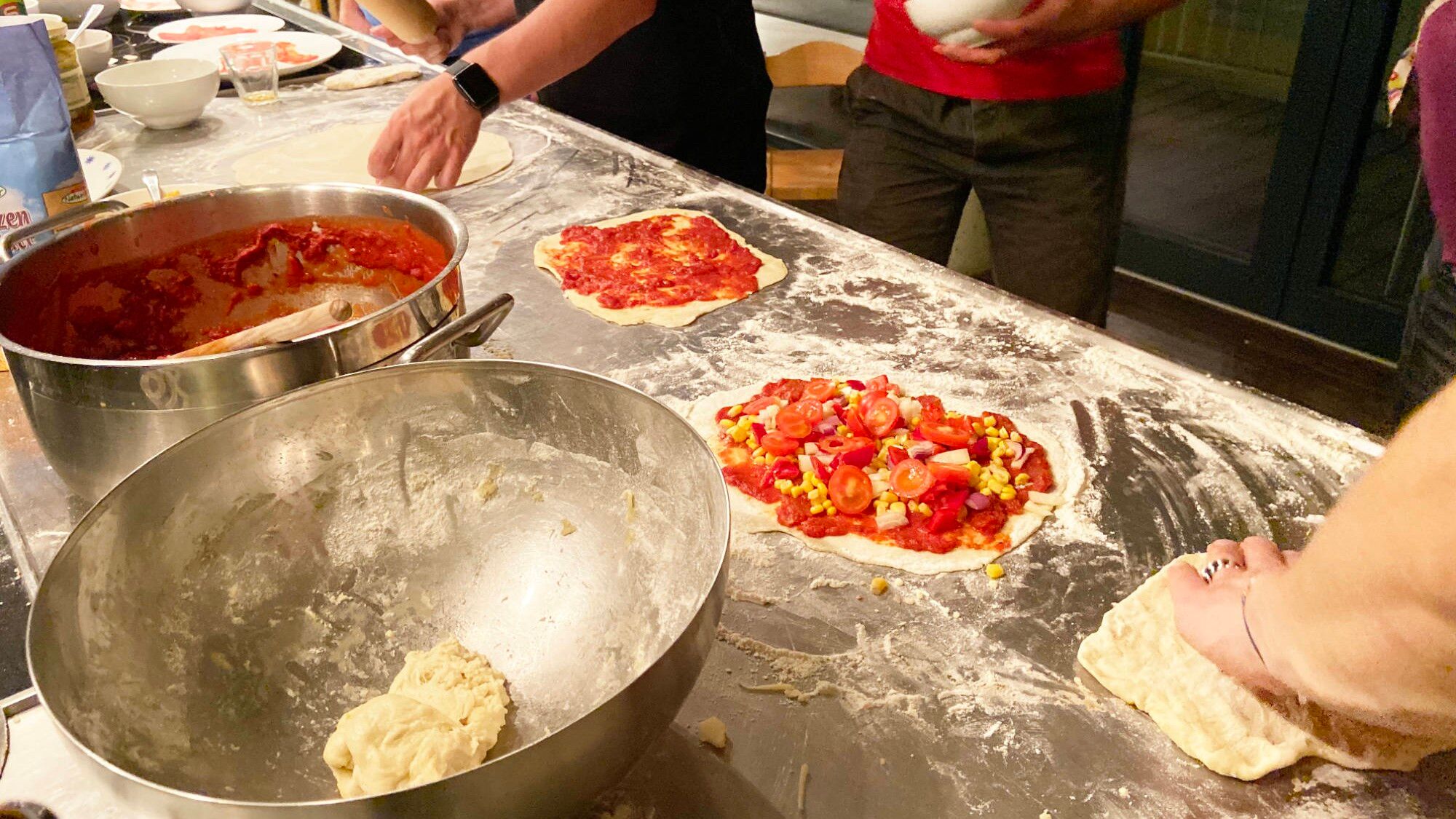 self-made pizza on kitchen counter with flour